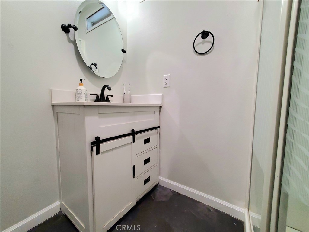 27361 Sierra Highway, Unit 19 Canyon Country, CA 91351 - Photo 18 of 26 a bathroom with a sink and mirror