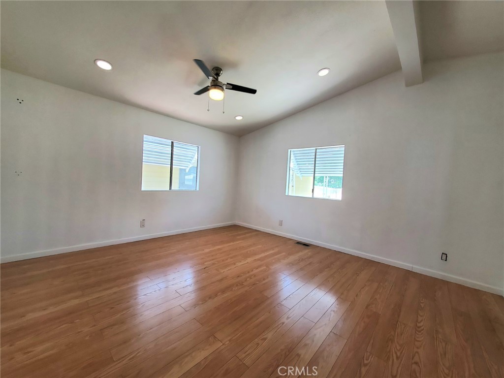 27361 Sierra Highway, Unit 19 Canyon Country, CA 91351 - Photo 19 of 26 a view of an empty room with a window and wooden floor