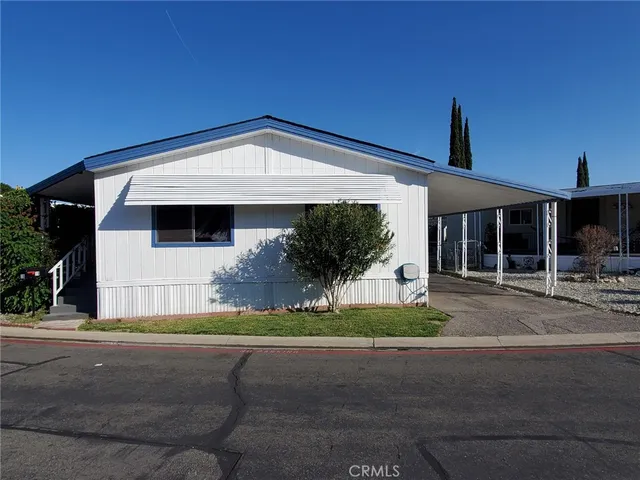 a front view of a house with a garden and yard