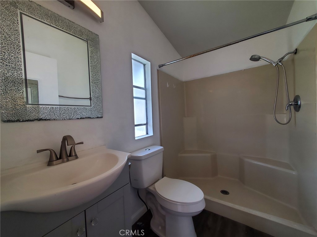 27361 Sierra Highway, Unit 19 Canyon Country, CA 91351 - Photo 21 of 26 a bathroom with a sink toilet and shower
