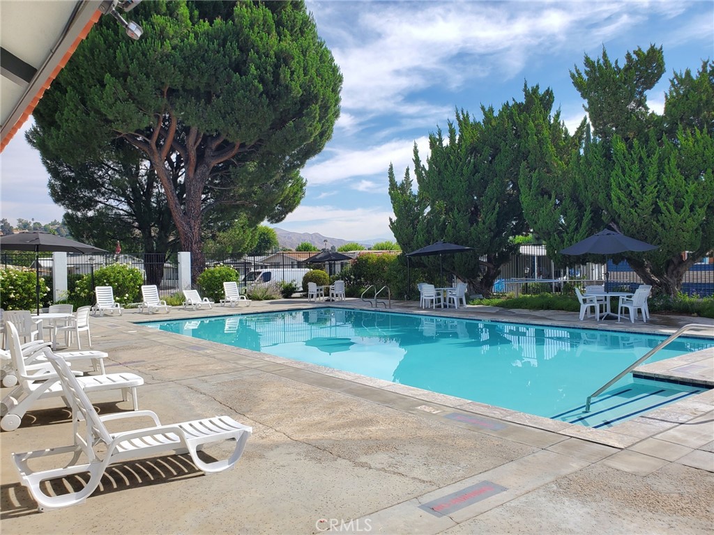 27361 Sierra Highway, Unit 19 Canyon Country, CA 91351 - Photo 26 of 26 a view of a swimming pool with lounge chairs in patio