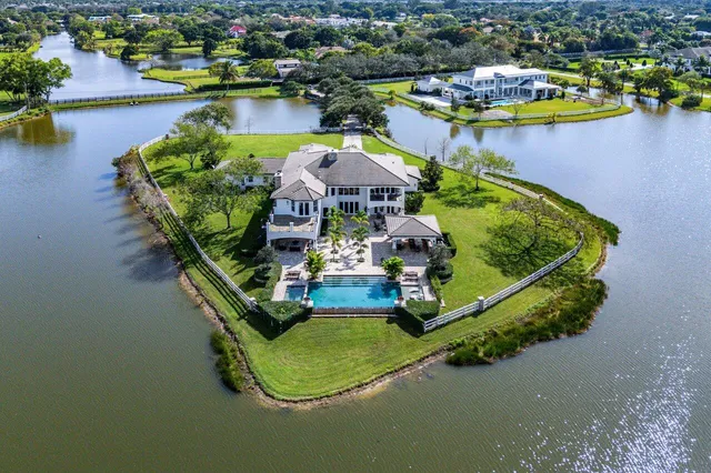 an aerial view of a house with a lake view
