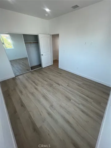 a bathroom with a granite countertop sink toilet a mirror and bathtub