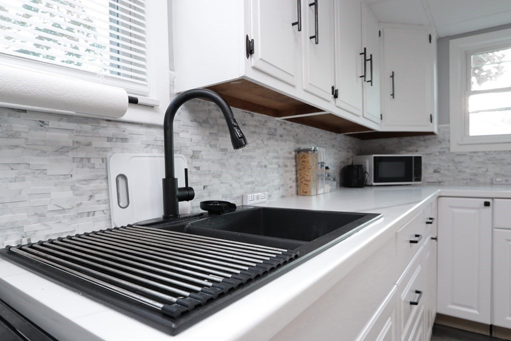 166 Laurelton Street Springfield, MA 01109 - Photo 7 of 34 a close view of a sink a counter and appliances in the kitchen