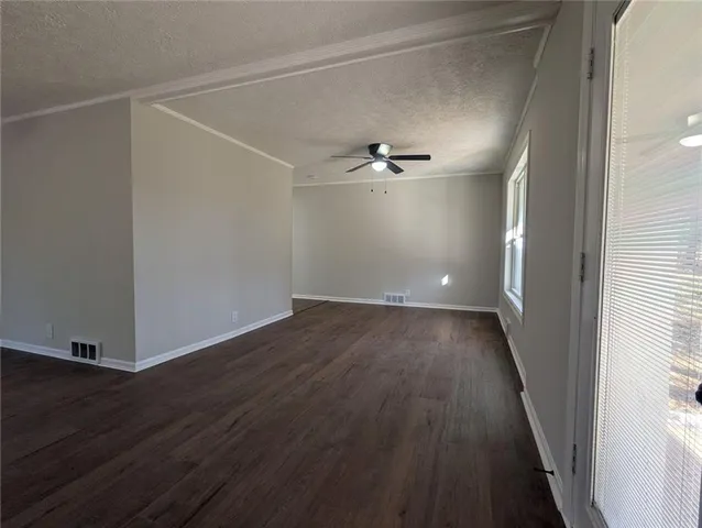 a view of a room with wooden floor