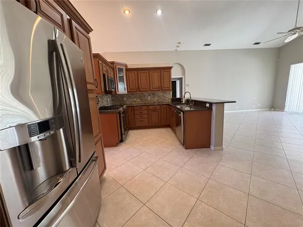a kitchen with stainless steel appliances granite countertop a refrigerator and a stove