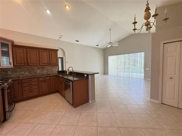 a kitchen with stainless steel appliances granite countertop a stove and cabinets