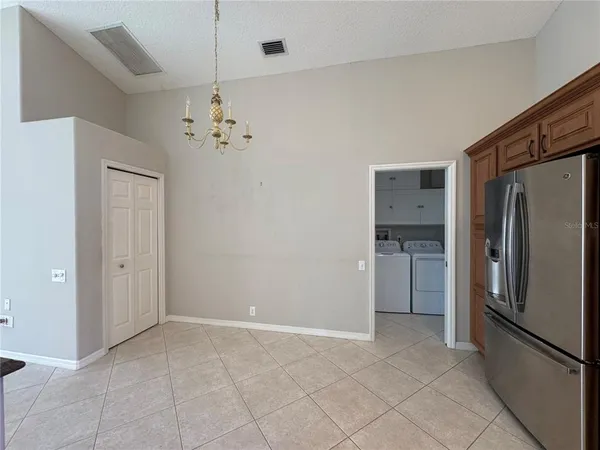 a view of a kitchen with a refrigerator and a stove top oven