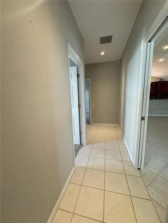 a view of hallway with a window and a white door