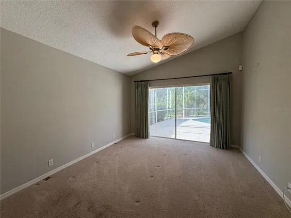 a view of a livingroom with a ceiling fan and window