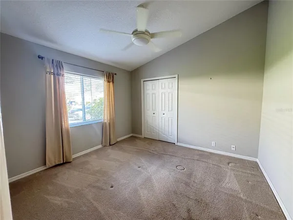 an empty room with windows and closet