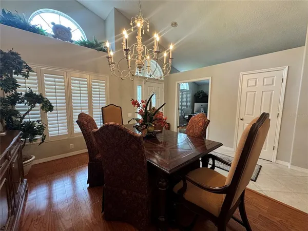 a view of a dining room with furniture wooden floor and chandelier