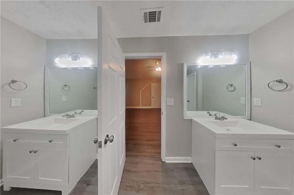 2958 Arden Ridge Terrace Suwanee, GA 30024 - Photo 12 of 20 a spacious bathroom with a sink a mirror a shower and a mirror