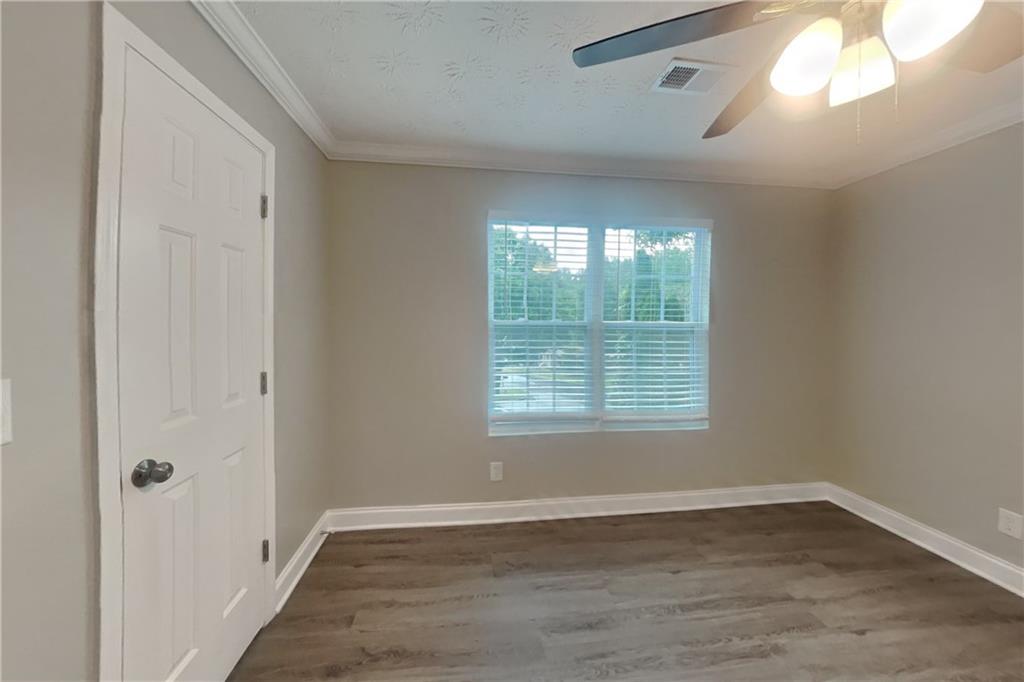 2958 Arden Ridge Terrace Suwanee, GA 30024 - Photo 14 of 20 a view of an empty room with wooden floor and a window