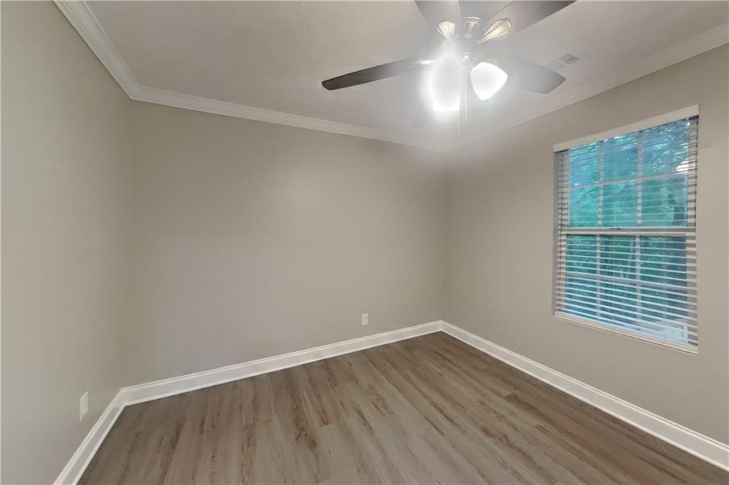 2958 Arden Ridge Terrace Suwanee, GA 30024 - Photo 16 of 20 wooden floor in an empty room with a window