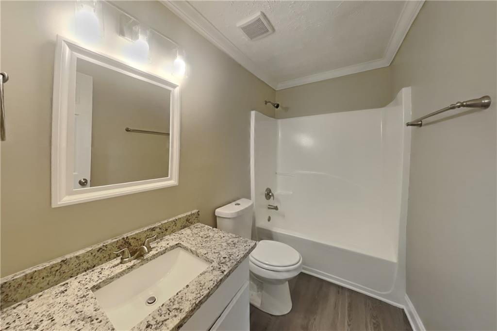 2958 Arden Ridge Terrace Suwanee, GA 30024 - Photo 17 of 20 a bathroom with a granite countertop sink toilet and shower