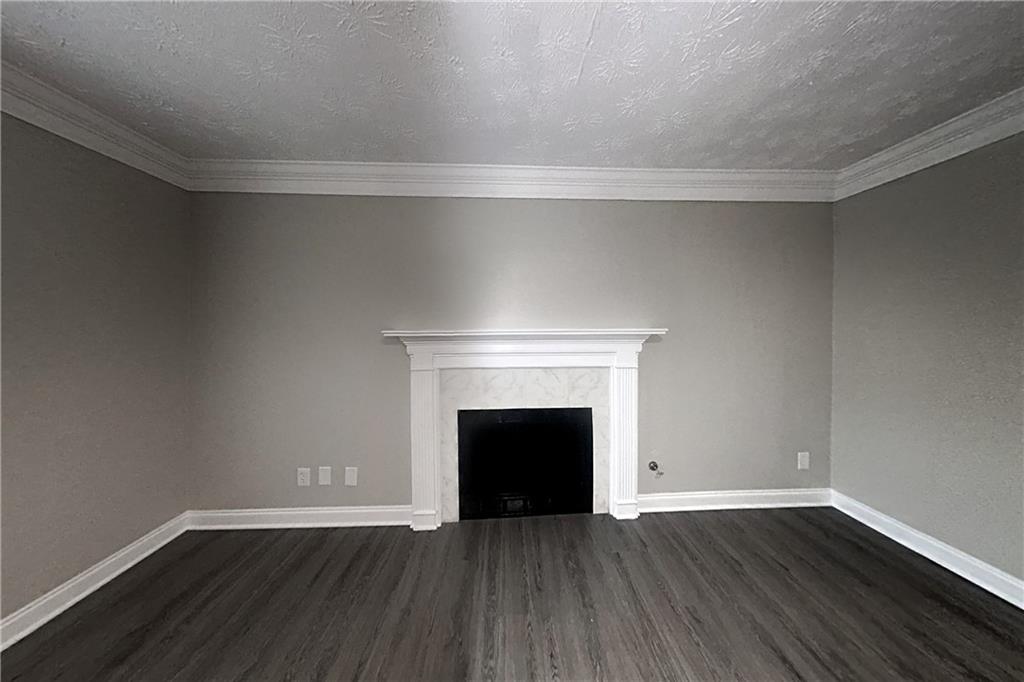 2958 Arden Ridge Terrace Suwanee, GA 30024 - Photo 3 of 20 an empty room with wooden floor and fireplace