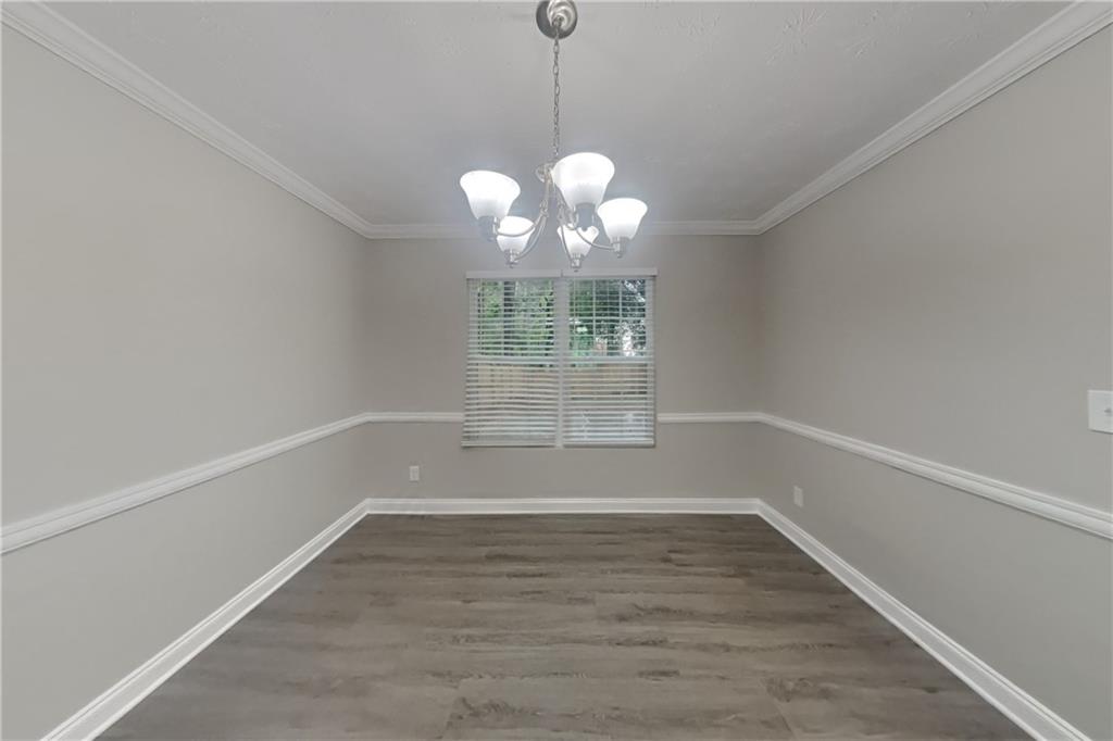 2958 Arden Ridge Terrace Suwanee, GA 30024 - Photo 7 of 20 a view of wooden floor and a chandelier in white room