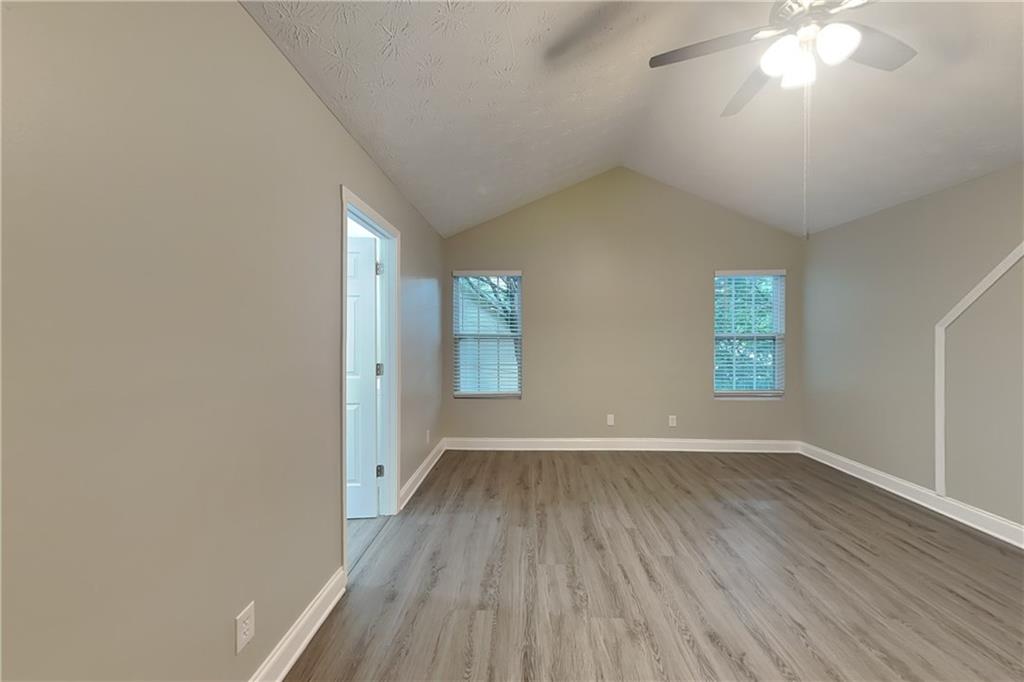 2958 Arden Ridge Terrace Suwanee, GA 30024 - Photo 10 of 20 an empty room with wooden floor and windows
