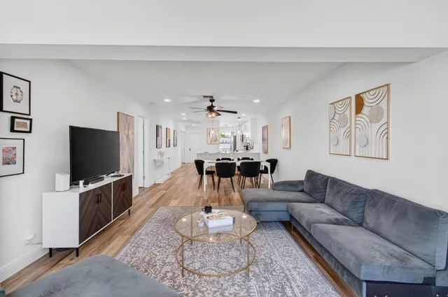 a kitchen with stainless steel appliances white cabinets and a stove top oven