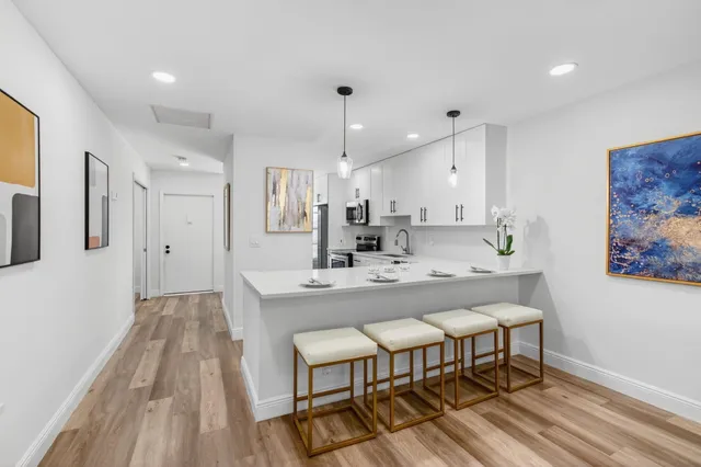 a kitchen with kitchen island a sink stainless steel appliances and cabinets