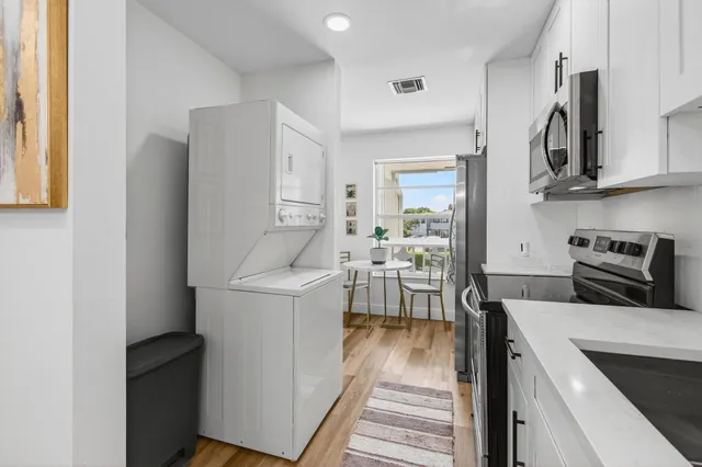a kitchen with stainless steel appliances a refrigerator and a table