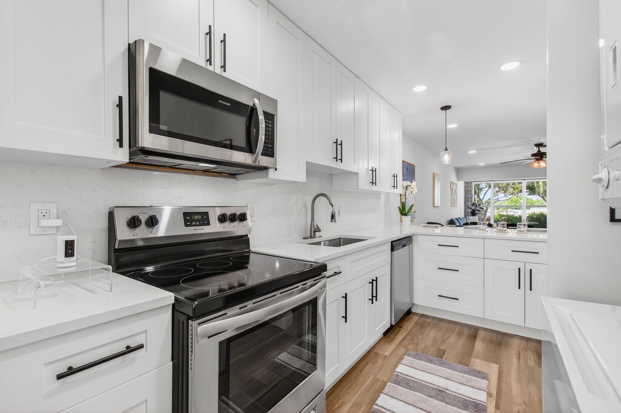 2825 Southwest 13th Street, Unit 204 Delray Beach, FL 33445 - Photo 22 of 62 a kitchen with a sink stove and microwave