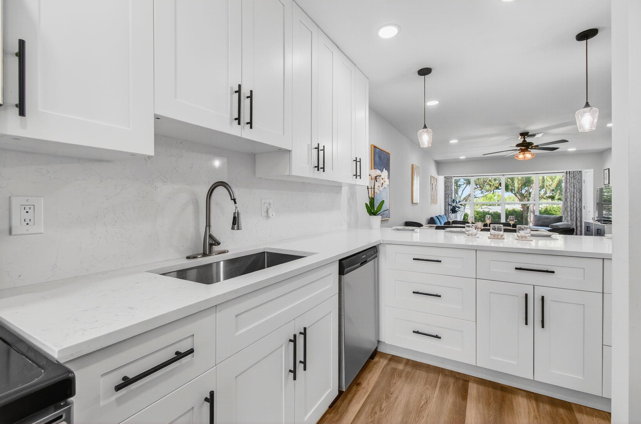 2825 Southwest 13th Street, Unit 204 Delray Beach, FL 33445 - Photo 23 of 62 a kitchen with kitchen island a sink stainless steel appliances and cabinets