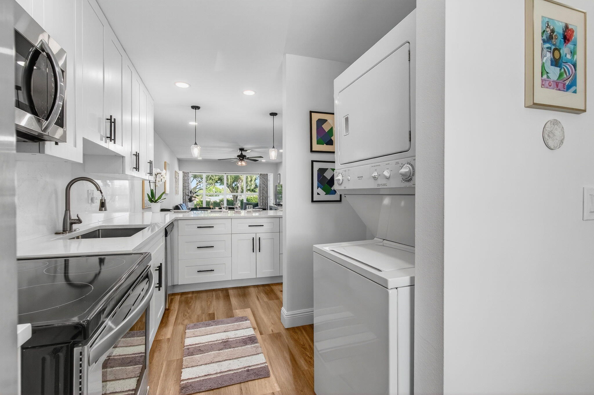 2825 Southwest 13th Street, Unit 204 Delray Beach, FL 33445 - Photo 24 of 62 a kitchen with white cabinets and sink