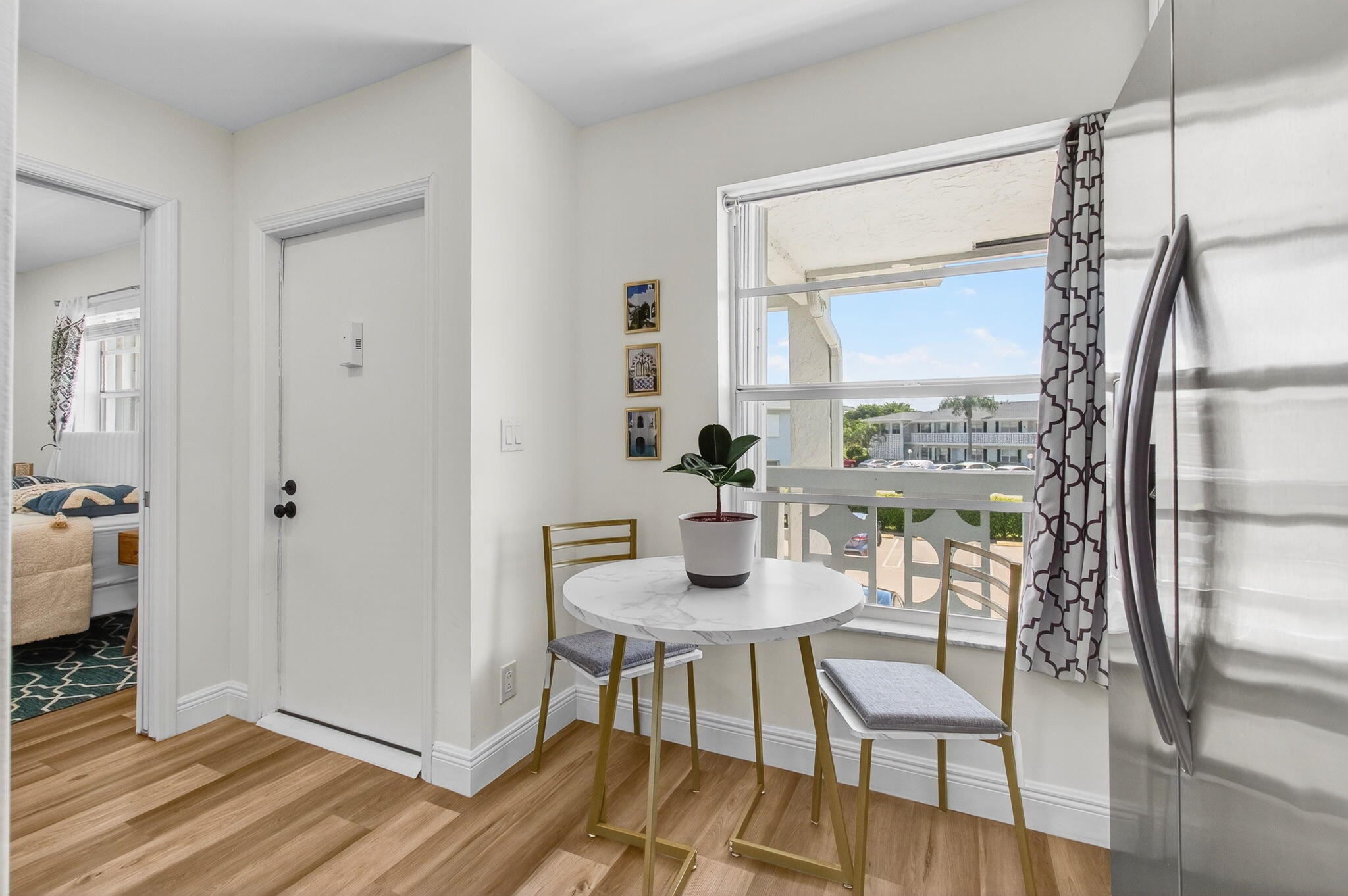 2825 Southwest 13th Street, Unit 204 Delray Beach, FL 33445 - Photo 25 of 62 a view of a livingroom with furniture and wooden floor