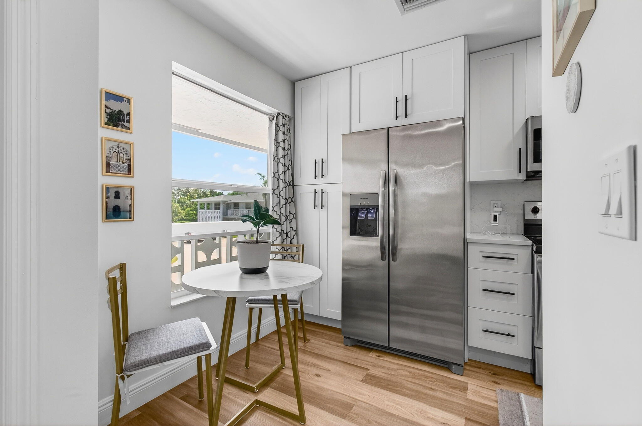 2825 Southwest 13th Street, Unit 204 Delray Beach, FL 33445 - Photo 26 of 62 a kitchen with stainless steel appliances a refrigerator and a table
