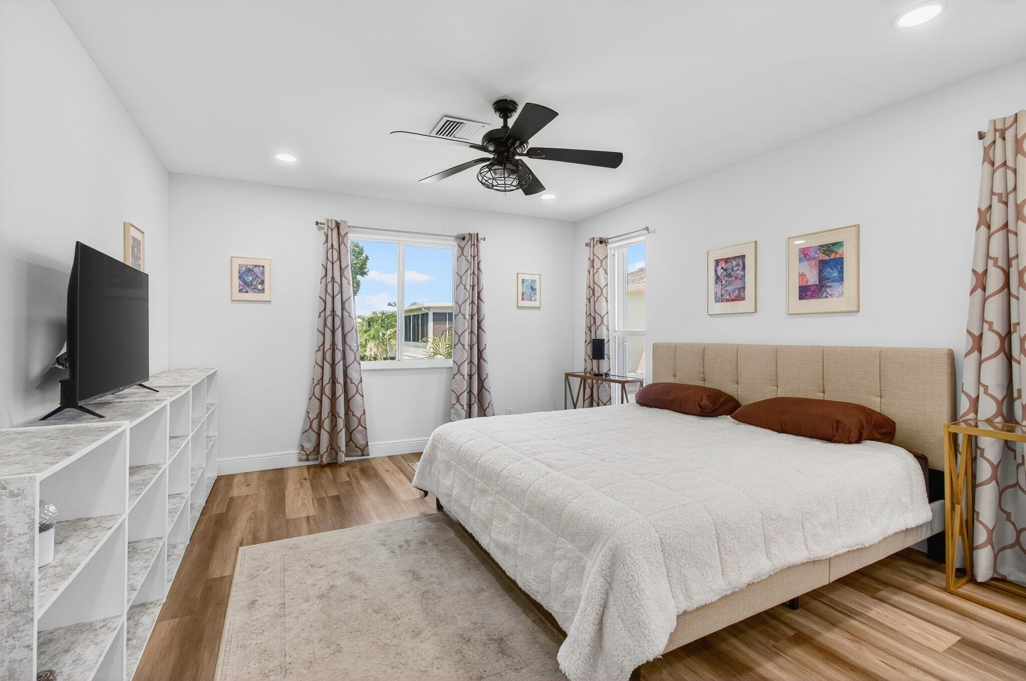 2825 Southwest 13th Street, Unit 204 Delray Beach, FL 33445 - Photo 29 of 62 a bedroom with a bed and a flat screen tv