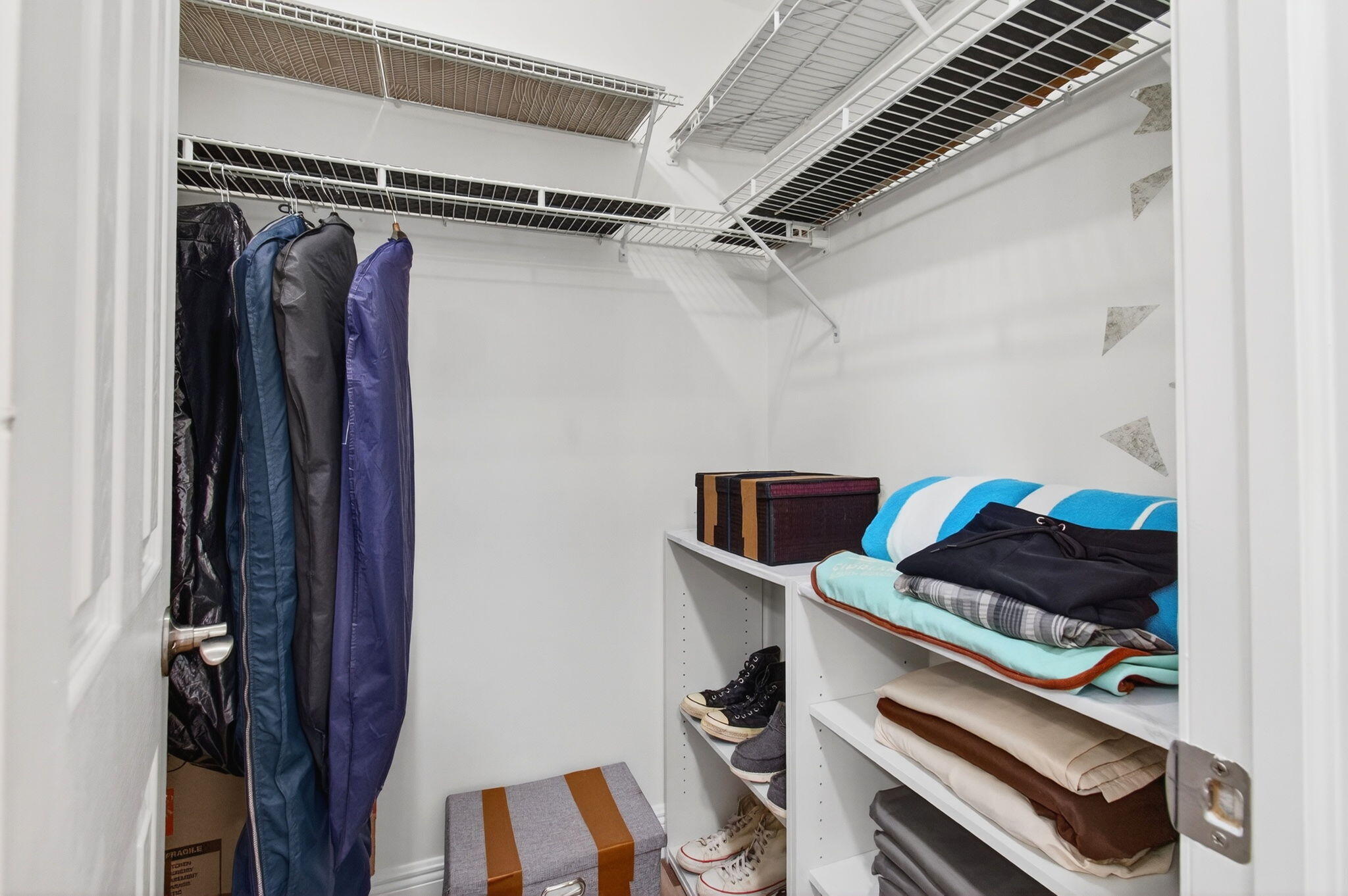 2825 Southwest 13th Street, Unit 204 Delray Beach, FL 33445 - Photo 34 of 62 a view of walk in closet with clothes and shoes