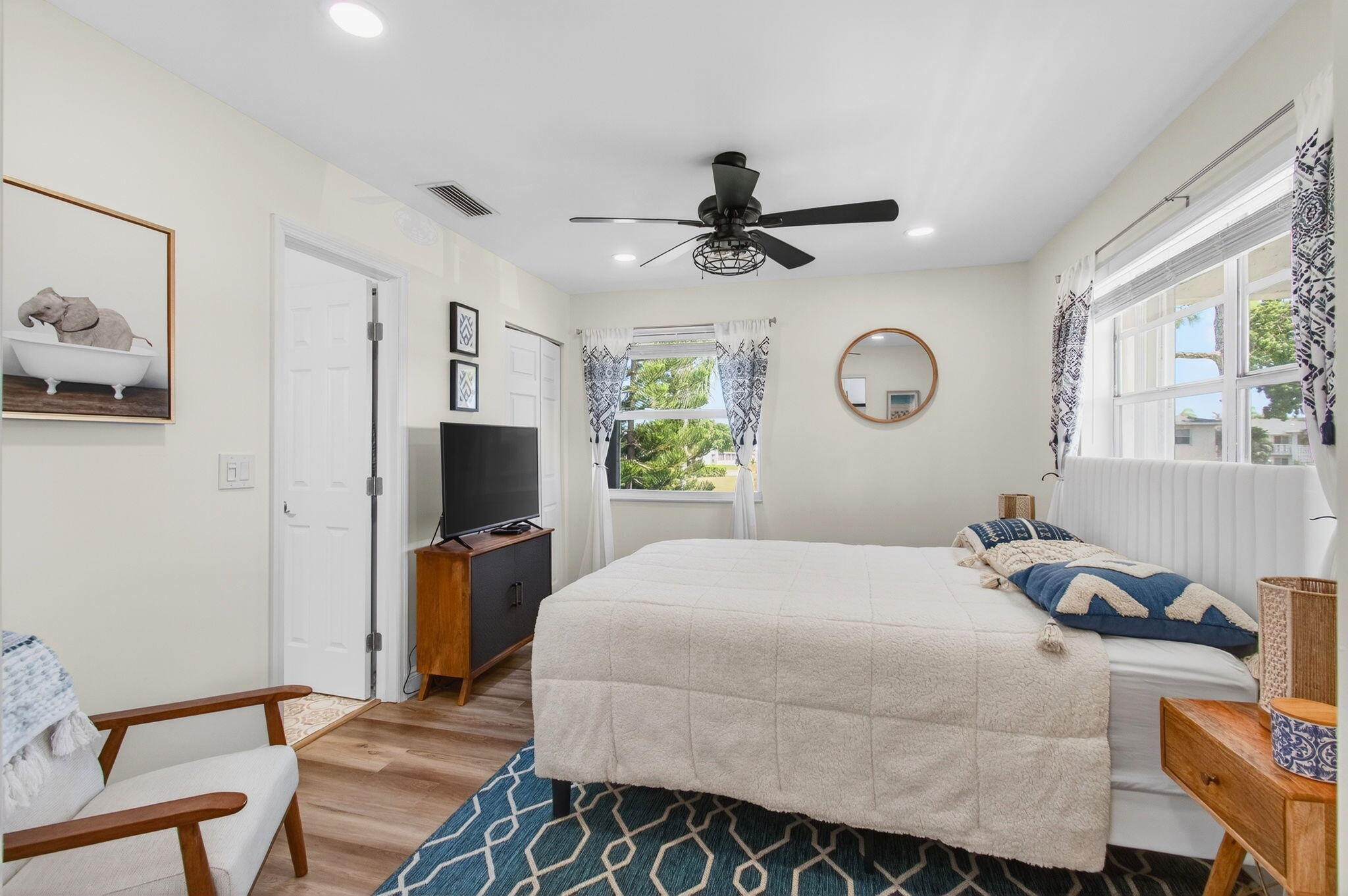 2825 Southwest 13th Street, Unit 204 Delray Beach, FL 33445 - Photo 36 of 62 a bedroom with a bed a window and a chandelier