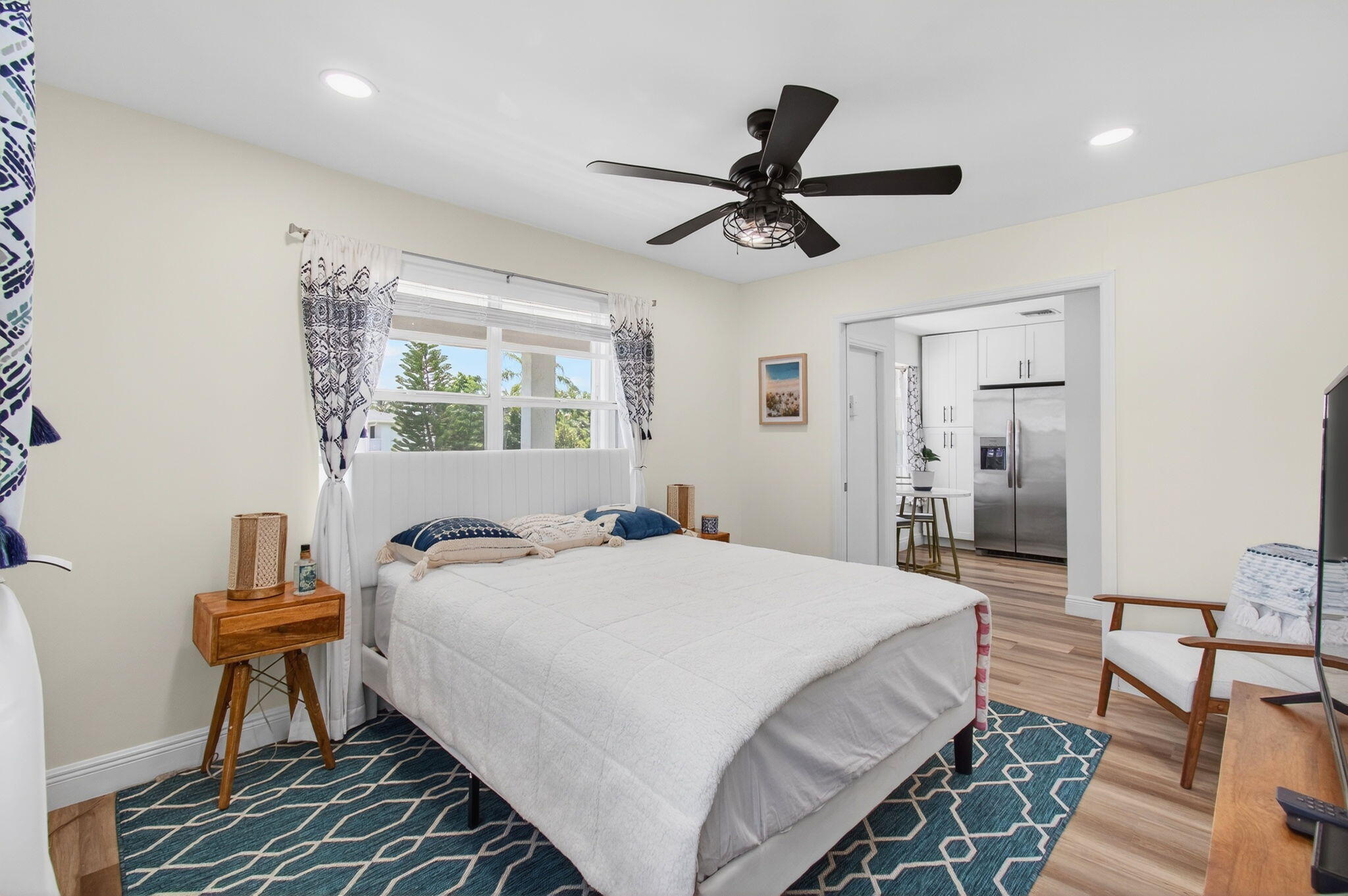 2825 Southwest 13th Street, Unit 204 Delray Beach, FL 33445 - Photo 37 of 62 a bedroom with a bed and a chandelier