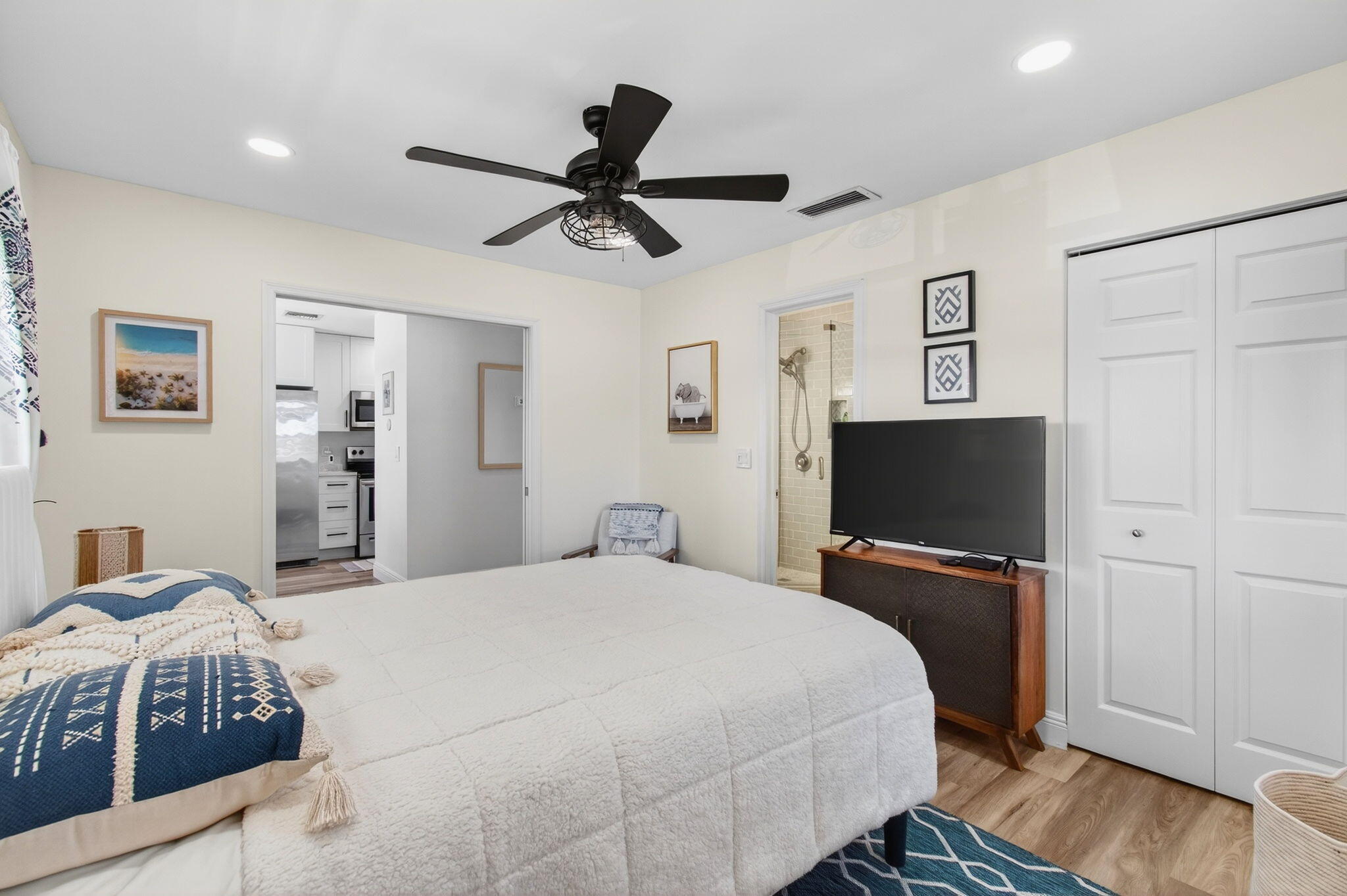 2825 Southwest 13th Street, Unit 204 Delray Beach, FL 33445 - Photo 38 of 62 a bedroom with a bed and a flat screen tv