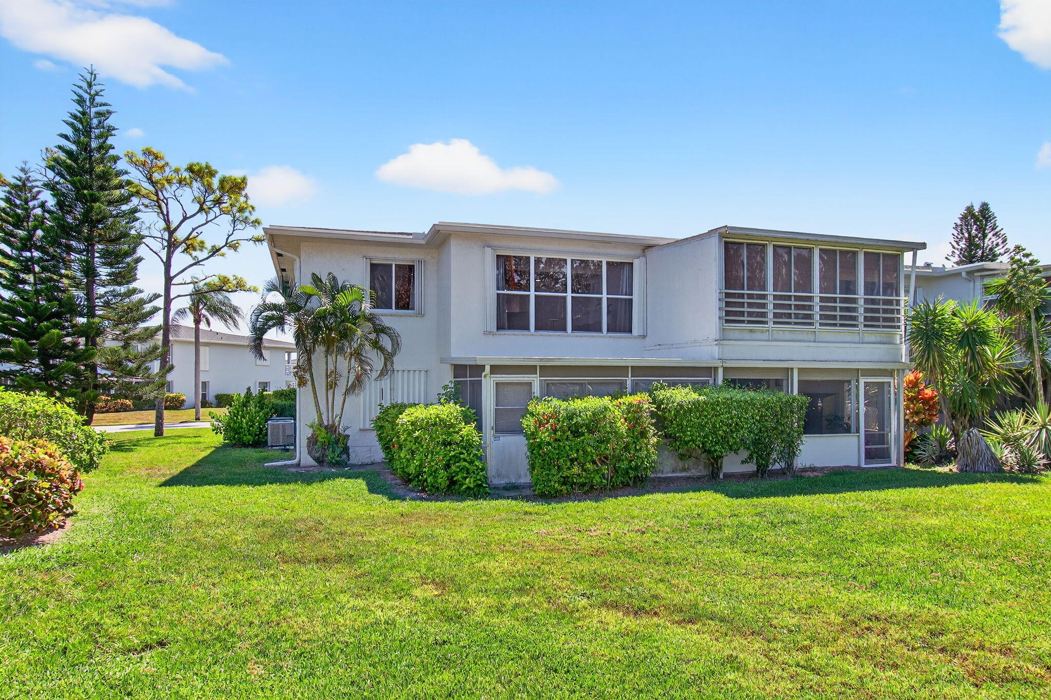 2825 Southwest 13th Street, Unit 204 Delray Beach, FL 33445 - Photo 44 of 62 a front view of a house with a yard