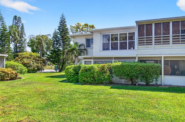 a view of a swimming pool with a garden and trees