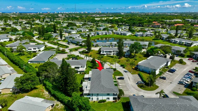 an aerial view of residential houses with outdoor space and street view