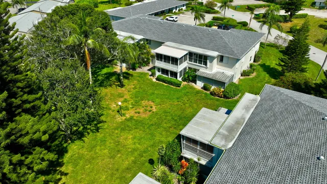 an aerial view of a house with a garden and lake view