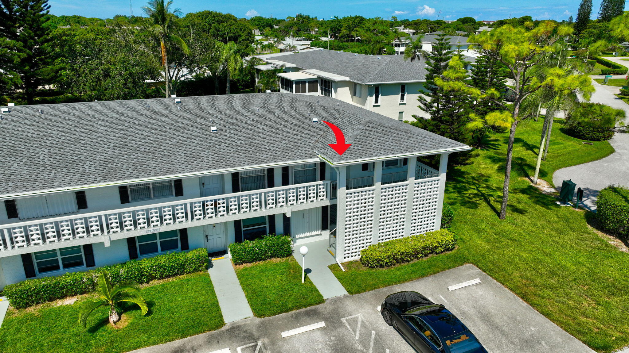 2825 Southwest 13th Street, Unit 204 Delray Beach, FL 33445 - Photo 56 of 62 a front view of a house with a yard