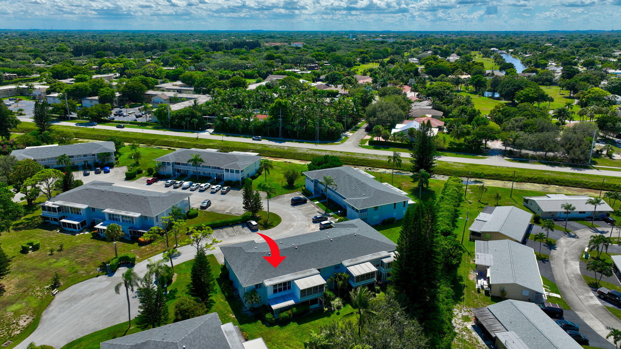 2825 Southwest 13th Street, Unit 204 Delray Beach, FL 33445 - Photo 60 of 62 an aerial view of a house with a garden and lake view