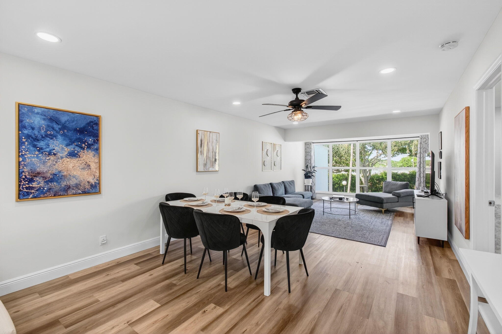 2825 Southwest 13th Street, Unit 204 Delray Beach, FL 33445 - Photo 9 of 62 a view of a dining room with furniture window and wooden floor