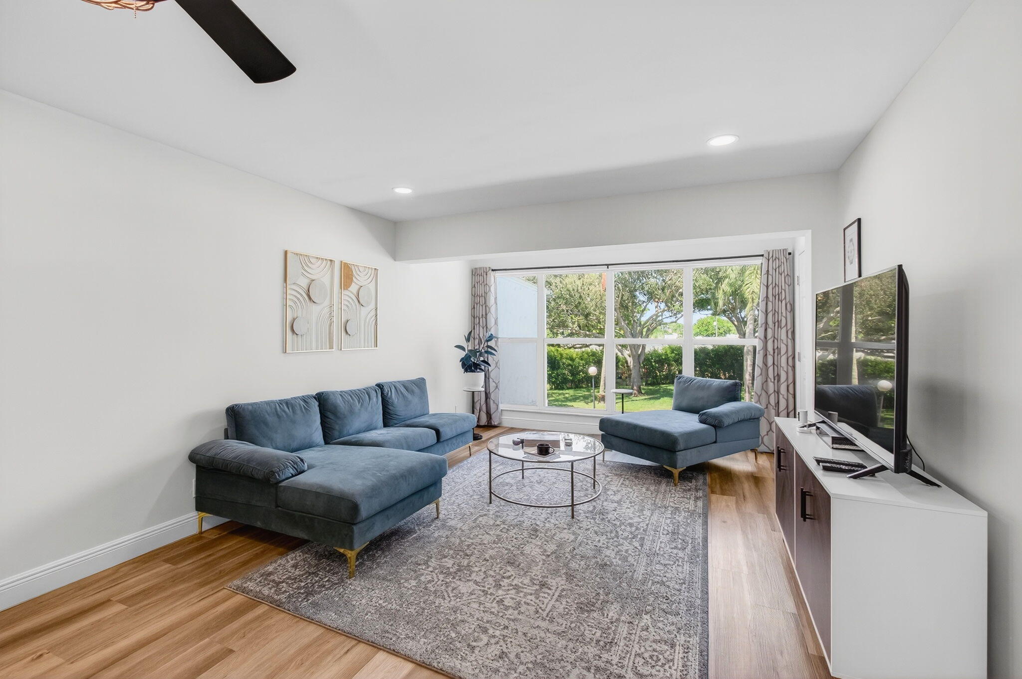 2825 Southwest 13th Street, Unit 204 Delray Beach, FL 33445 - Photo 10 of 62 a living room with furniture and a flat screen tv