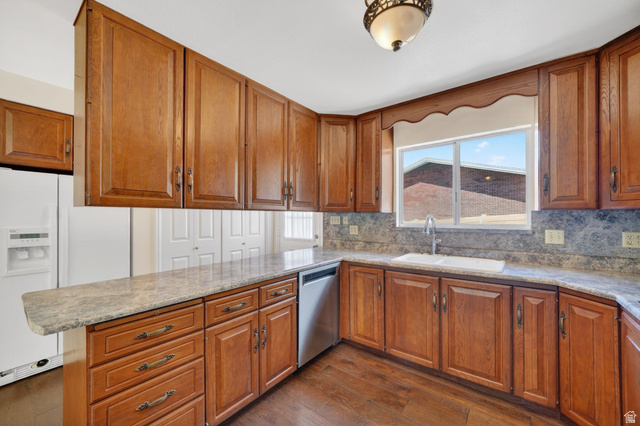 3120 North Apache Way Provo, UT 84604 - Photo 22 of 58 Kitchen featuring wood-finish cabinetry, stone-look countertops, and a complementary backsplash