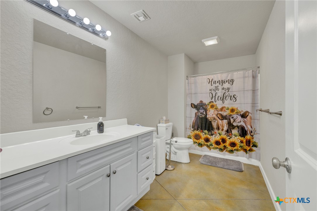 305 Lake Crest Spring Branch, TX 78070 - Photo 21 of 38 a bathroom with a sink mirror and vanity