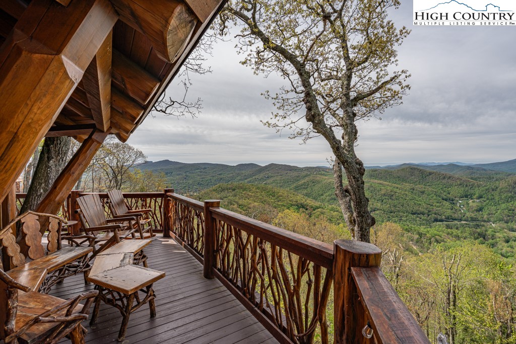 77 Eagles Nest Trail Banner Elk, NC 28604 - Photo 33 of 44 a view of a balcony with wooden chairs and a table
