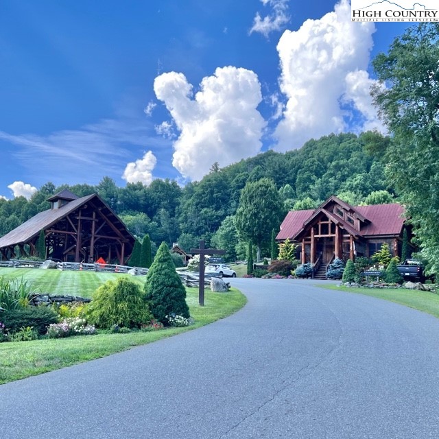 77 Eagles Nest Trail Banner Elk, NC 28604 - Photo 44 of 44 a view of a house with a yard and table under an umbrella