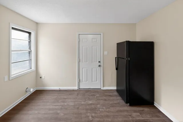 an empty room with windows and closet