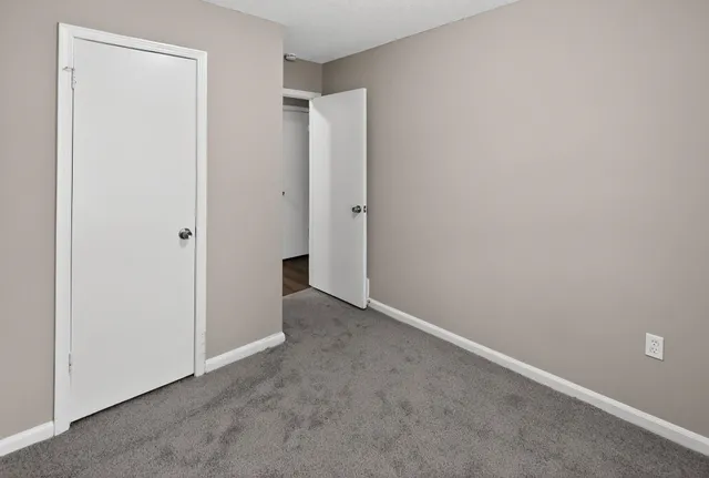 an empty room with closet area